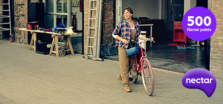 A woman carrying a bicycle