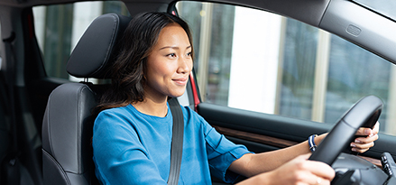 Woman driving in car.