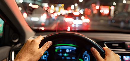 Woman on the steering wheel in traffic.