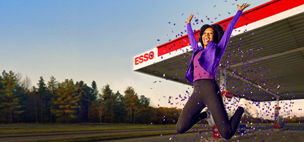 A person jumps in front of an Esso petrol station as purple confetti falls around them. The image promotes the Esso and Nectar Millionaire prize campaign.